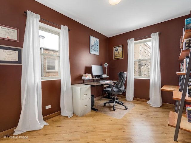 office space featuring baseboards and light wood-style floors