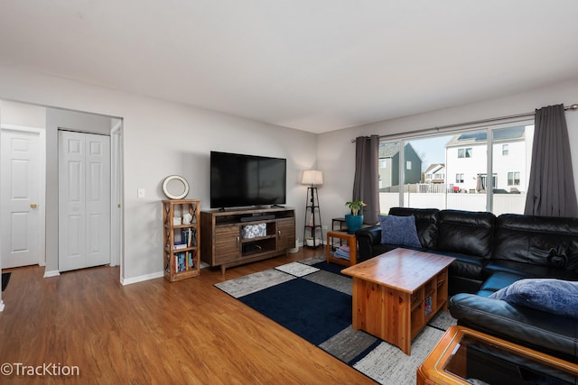 living area with wood finished floors and baseboards