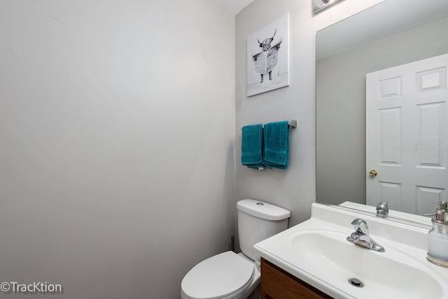 bathroom with toilet and vanity