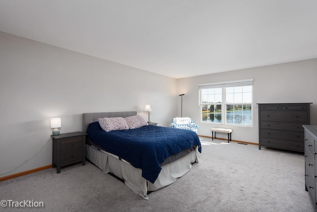 bedroom with baseboards and carpet flooring