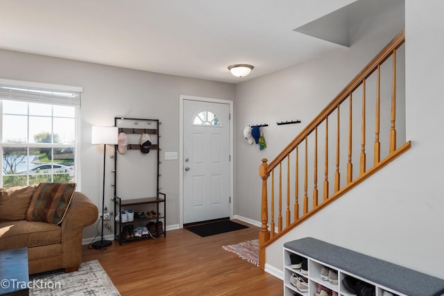 foyer entrance featuring stairway, wood finished floors, and baseboards