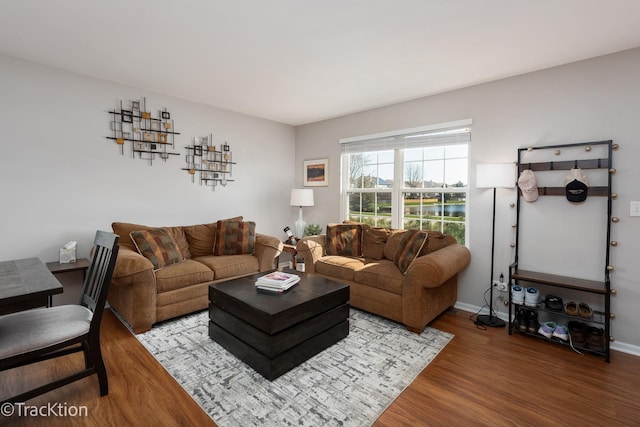 living area featuring wood finished floors and baseboards