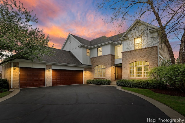 4 Shadow Creek Ct, Lake In The Hills, IL 60156 - view of front of property featuring a garage, brick siding, driveway, and board and batten siding