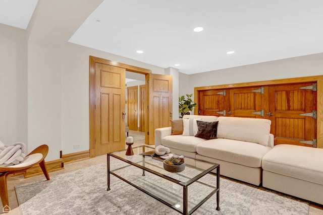 living room featuring baseboards and recessed lighting