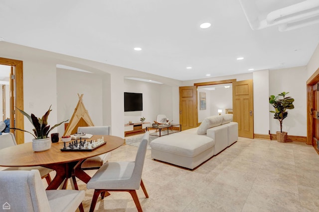living room with baseboards and recessed lighting
