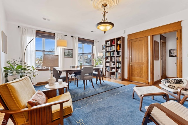 interior space featuring light wood finished floors, baseboards, and visible vents