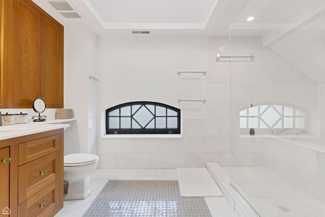 bathroom featuring vanity, toilet, tiled shower, and visible vents
