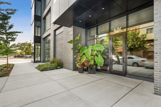 doorway to property with brick siding
