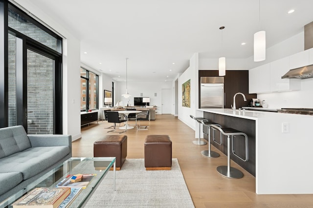 living room with light wood-style flooring and recessed lighting