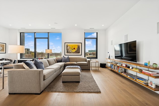 living room with hardwood / wood-style floors, a healthy amount of sunlight, and recessed lighting