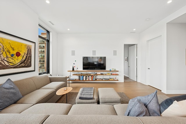 living room featuring recessed lighting and wood finished floors
