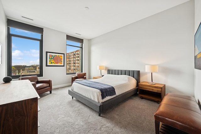 bedroom with baseboards, multiple windows, carpet flooring, and visible vents