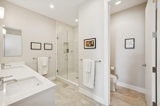 bathroom with toilet, baseboards, and a sink