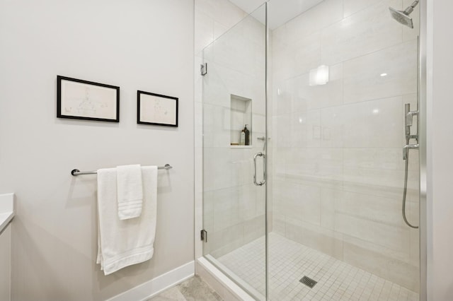 full bathroom featuring a stall shower and baseboards