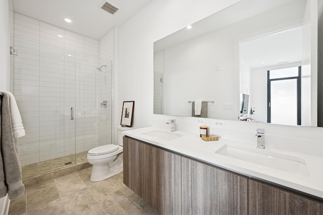 bathroom with toilet, visible vents, a sink, and a shower stall