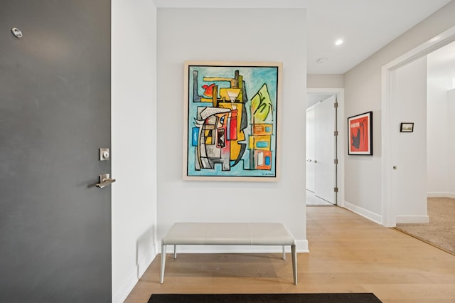 corridor with recessed lighting, baseboards, and wood finished floors