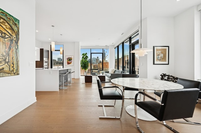 dining room with recessed lighting, baseboards, and wood finished floors