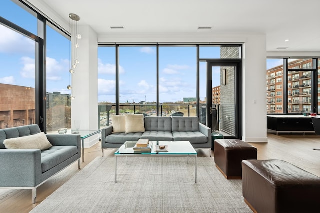 sunroom featuring visible vents and plenty of natural light
