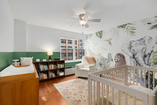 bedroom with wood finished floors and ceiling fan