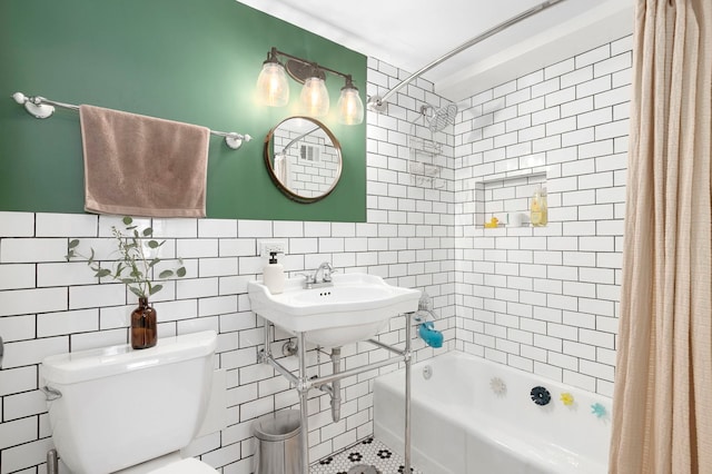 full bath featuring tile walls, shower / tub combo, and toilet