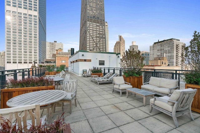view of patio featuring a view of skyline, an outdoor hangout area, and a balcony