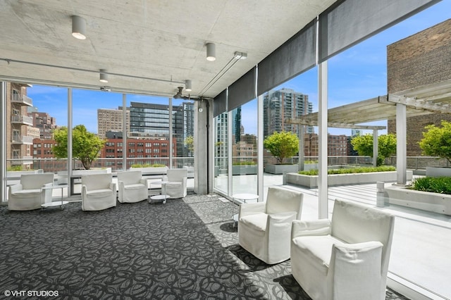 sunroom featuring a city view