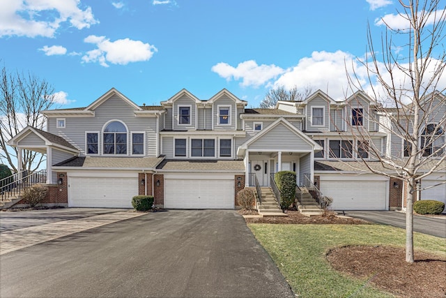 9163 Falcon Greens Dr, Lakewood, IL 60014 - view of front facade with brick siding, an attached garage, asphalt driveway, and a front lawn