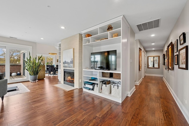 518 Winnetka Ave Unit 301, Winnetka, IL 60093 - unfurnished living room with visible vents, wood finished floors, baseboards, and a warm lit fireplace