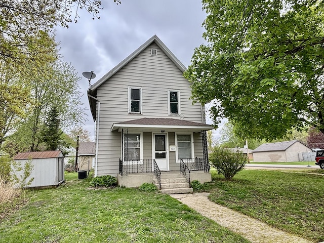 view of front of house featuring a porch, an outdoor structure, a shed, and a front yard