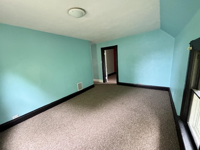 carpeted empty room with visible vents and baseboards