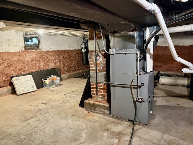unfinished below grade area featuring heating unit