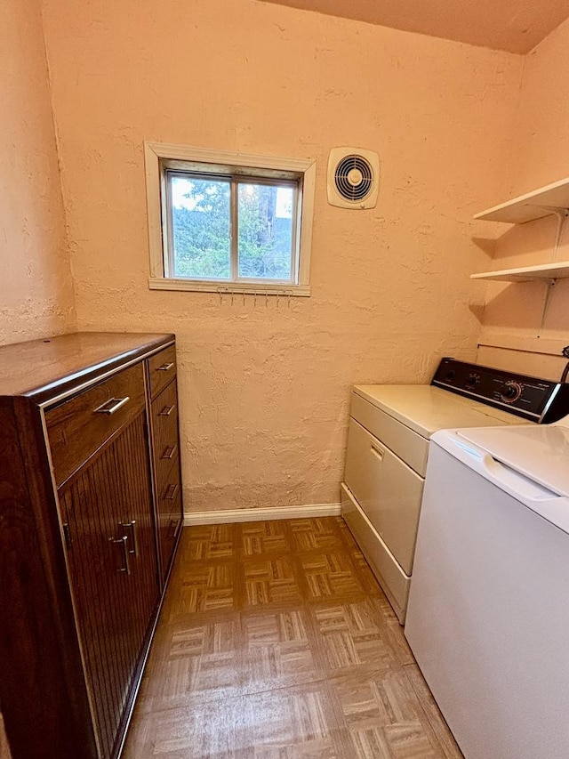 washroom with washer and clothes dryer, cabinet space, baseboards, and visible vents