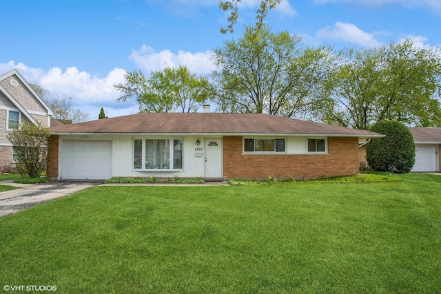 single story home with aphalt driveway, an attached garage, brick siding, a front yard, and a chimney