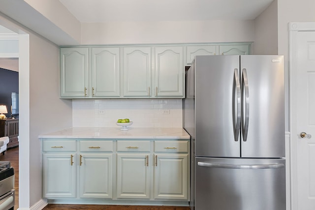kitchen featuring freestanding refrigerator and tasteful backsplash