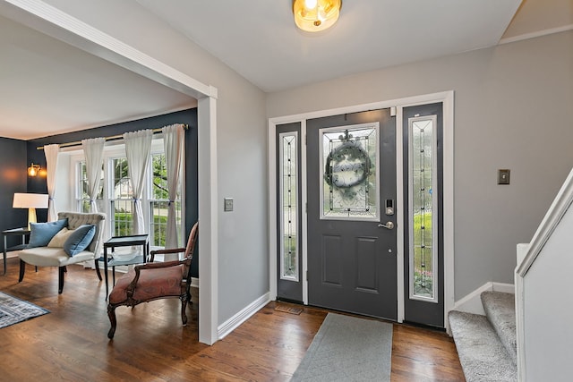 entryway with baseboards, dark wood finished floors, and stairs