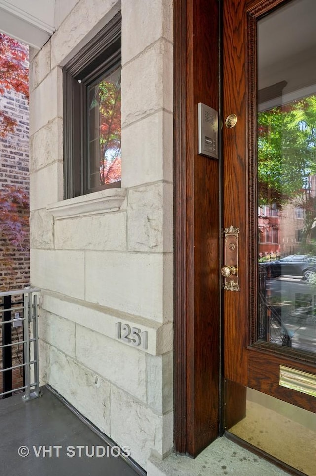 doorway to property with stone siding