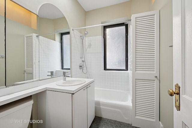 bathroom featuring toilet, vanity, and tub / shower combination