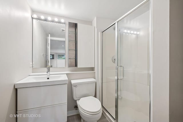 full bath with toilet, a stall shower, and vanity