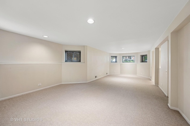 carpeted empty room featuring recessed lighting and baseboards