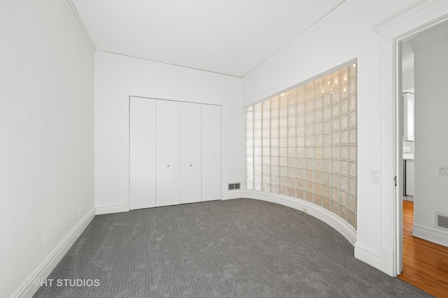unfurnished bedroom with carpet flooring, a closet, and baseboards