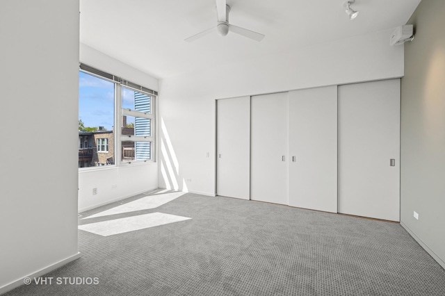 unfurnished bedroom featuring carpet flooring, a closet, baseboards, and ceiling fan