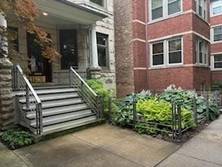 view of exterior entry featuring brick siding