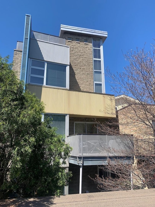 view of side of property featuring a balcony