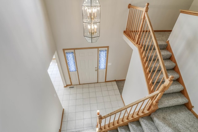 13860 Steeples Rd, Lemont, IL 60439 - tiled foyer entrance featuring a chandelier, baseboards, stairway, and a towering ceiling
