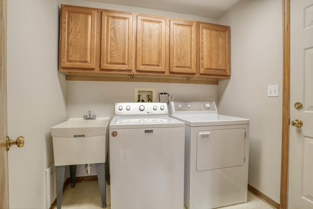 13860 Steeples Rd, Lemont, IL 60439 - clothes washing area with separate washer and dryer, cabinet space, baseboards, and light floors