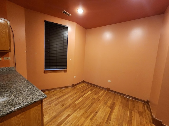 spare room featuring baseboards, light wood finished floors, and recessed lighting