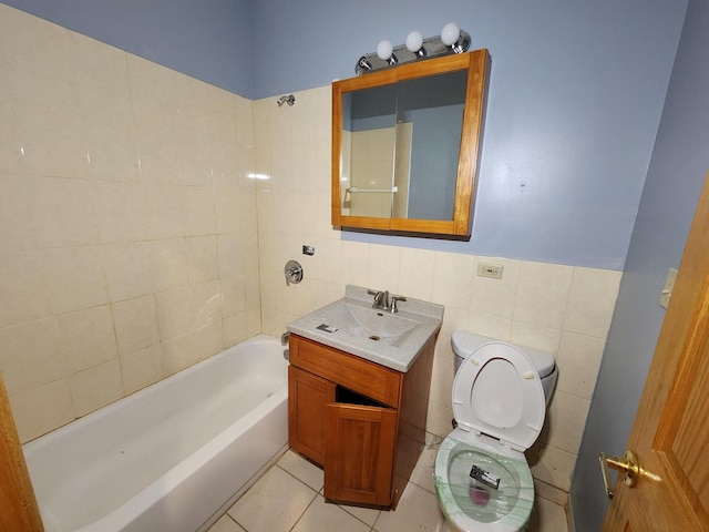 bathroom featuring tile walls, toilet,  shower combination, tile patterned flooring, and vanity
