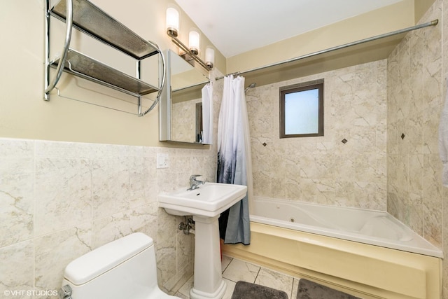 full bath with tile walls, shower / bath combo, and toilet
