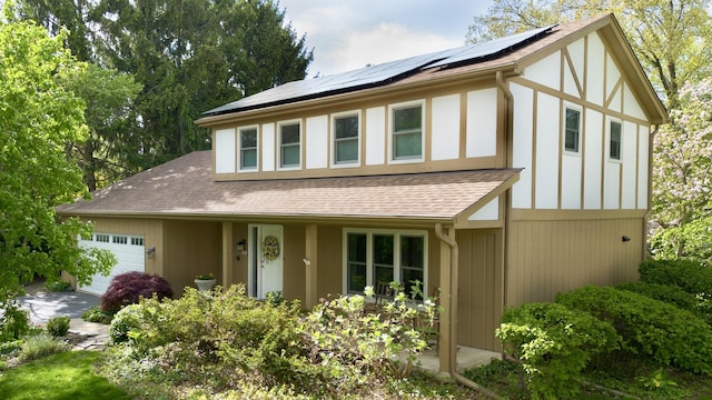 585 Apache Dr, Batavia, IL 60510 - view of front of home with a garage, solar panels, and a shingled roof