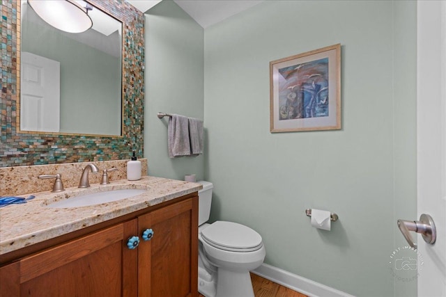 585 Apache Dr, Batavia, IL 60510 - bathroom featuring toilet, baseboards, vanity, and wood finished floors